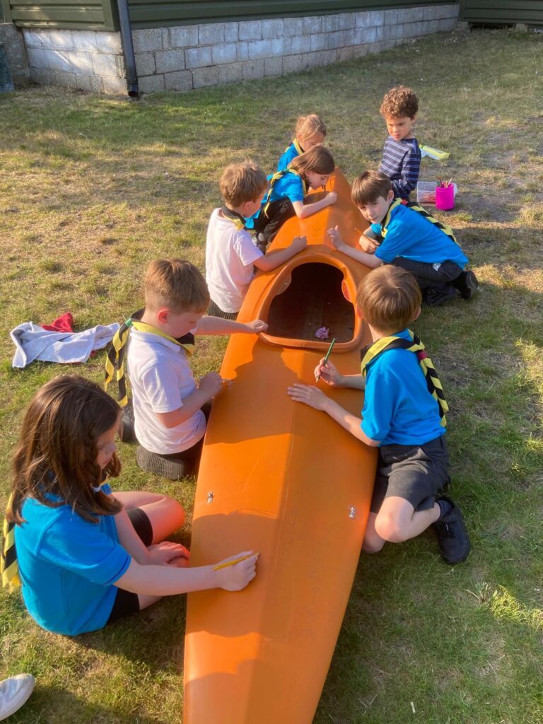 Beavers painting a kayak
